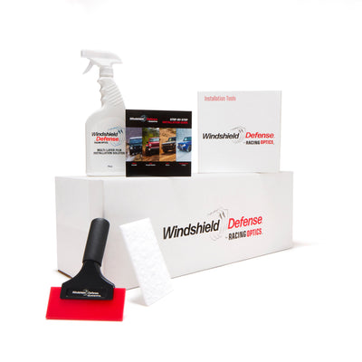 Windshield cleaning kit with spray bottle, squeegee, and installation tray on a white background
